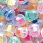 Close up view of small toys loaded in 1-inch acorn shaped vending capsules