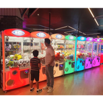 E-Claw 900 Crane Claw Machine Arcade Game Multiple Machines Bright Rainbow Colors Players Having Fun