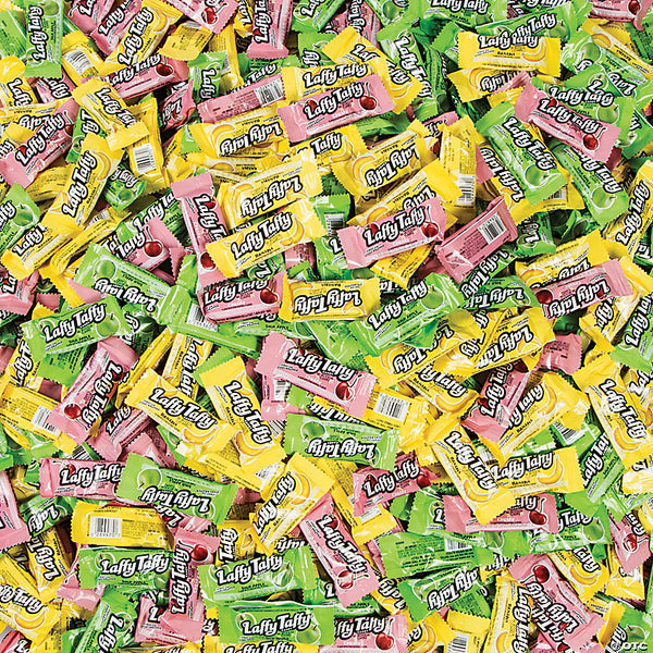 Large pile of laffy taffy wrapped candies in cherry, banana, and sour apple flavors