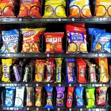 Close up view of candy and chips in a snack vending machine
